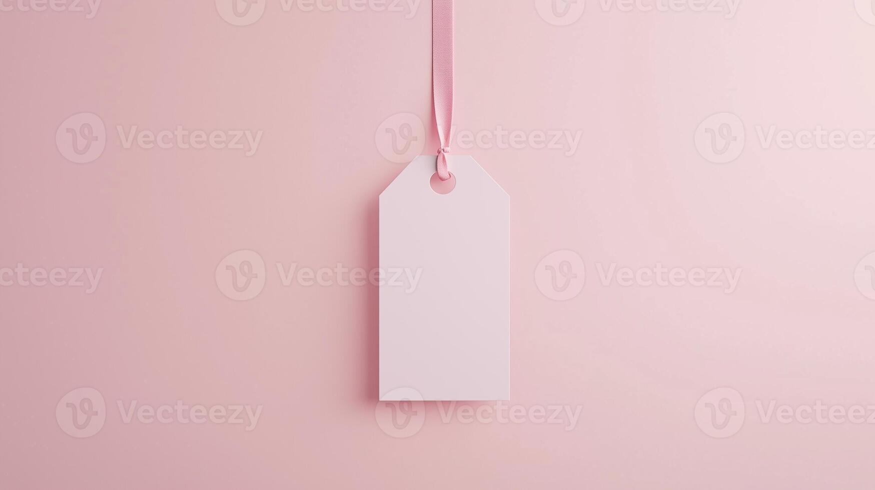 Paper price tag label white brand name with rope on solid pink background photo