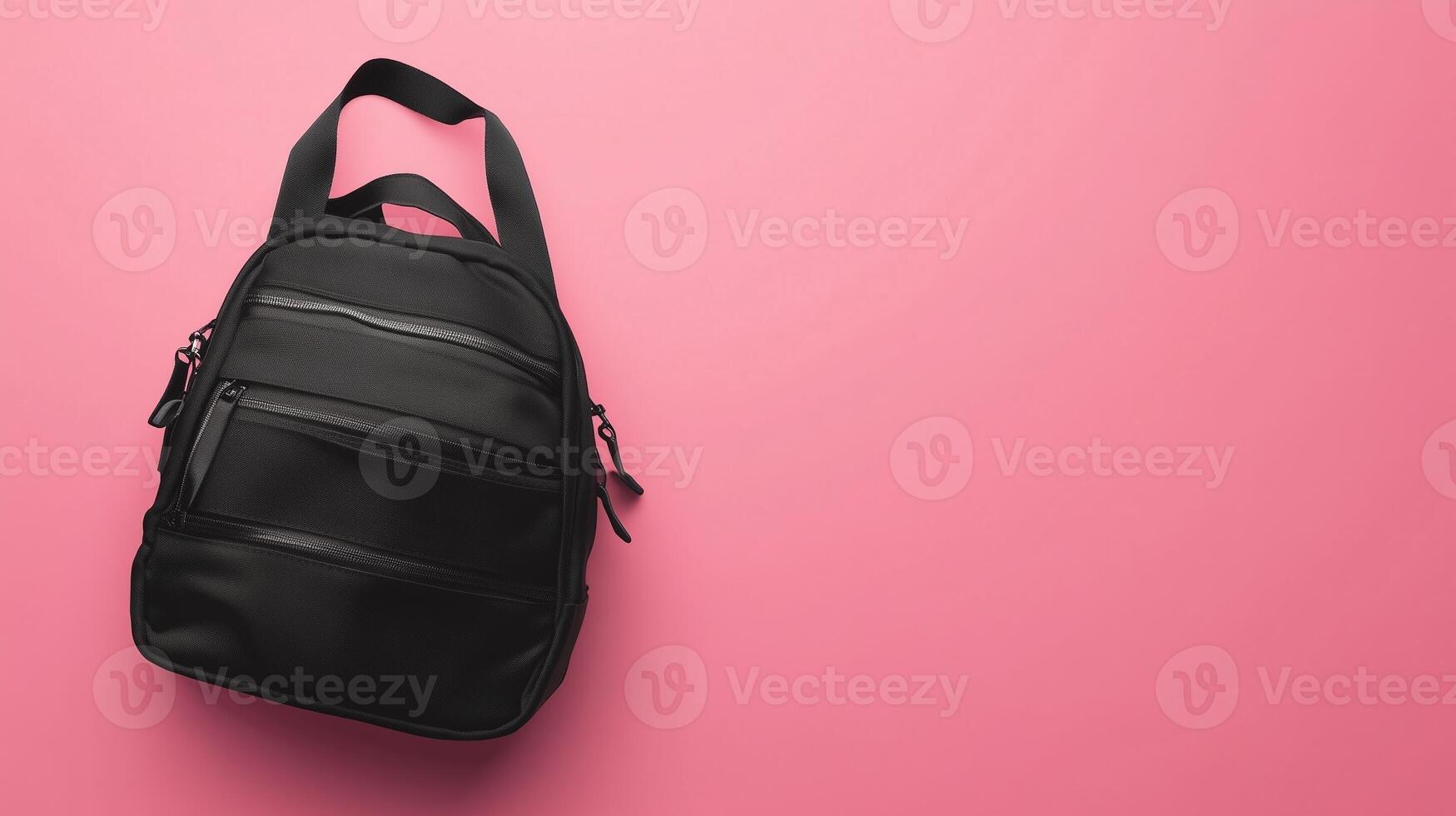 Black school bag a stationery place or working briefcase copy space pink background photo