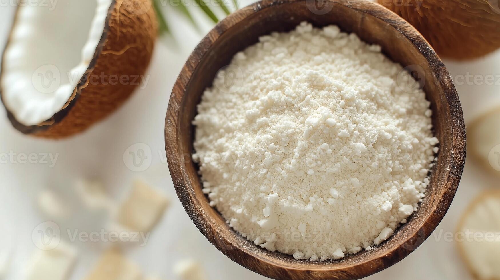 Coconut flour on brown wooden bowl and some Coconut slice for baking, gluten free copy space photo