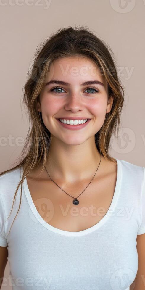 Bright smile of a young woman with long hair posing indoors photo