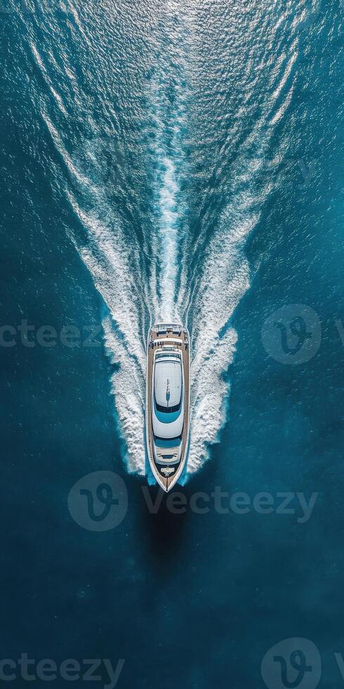 Luxurious yacht cruising through crystal clear waters on a sunny day photo