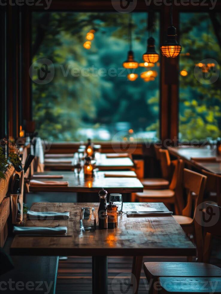 Cozy and empty restaurant interior with warm lighting during twilight photo