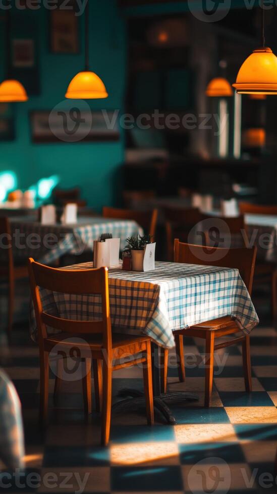 A cozy empty restaurant with warm lighting and checkered tables photo