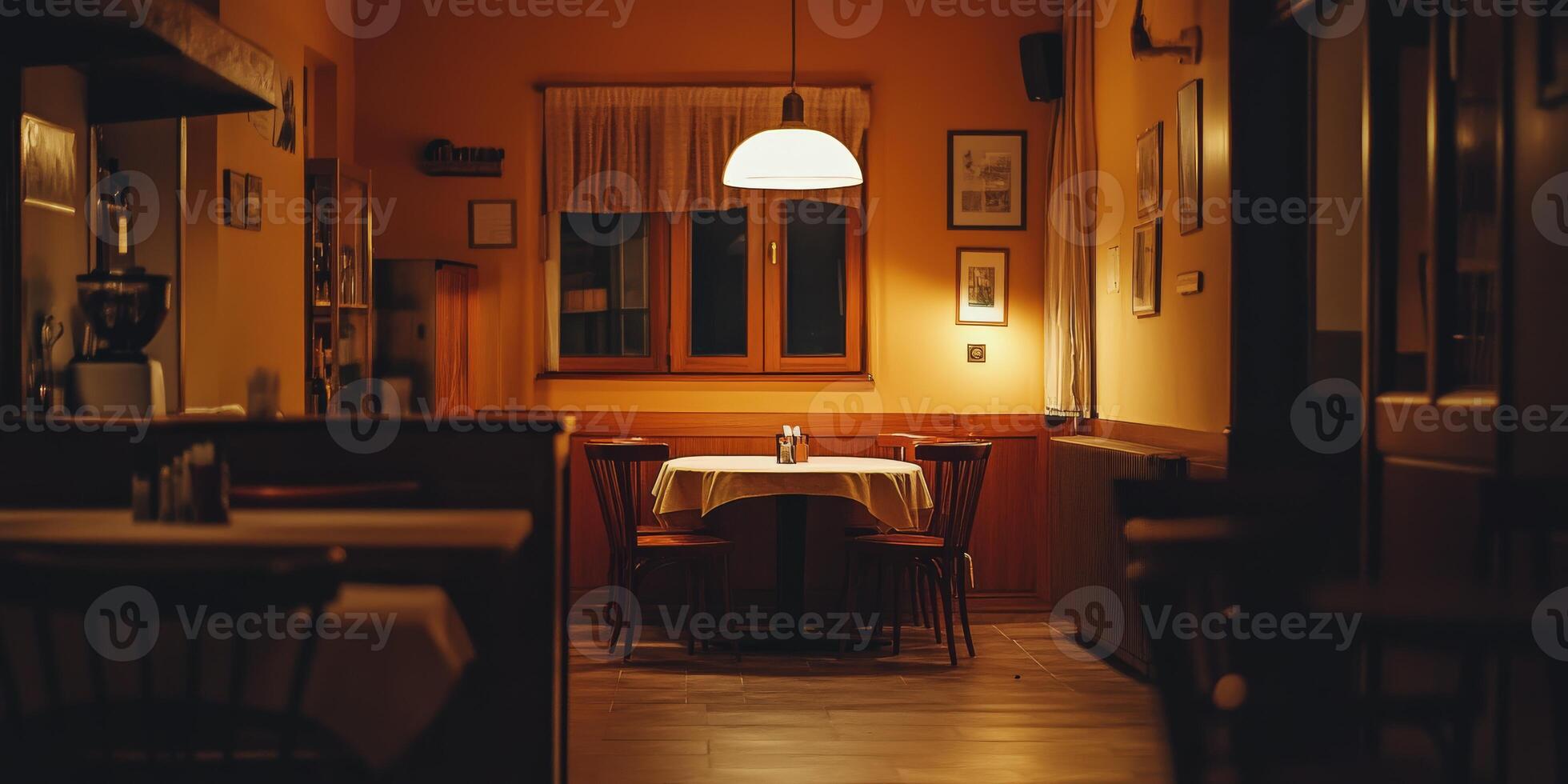 Cozy empty restaurant with warm lighting and a single table set for two photo