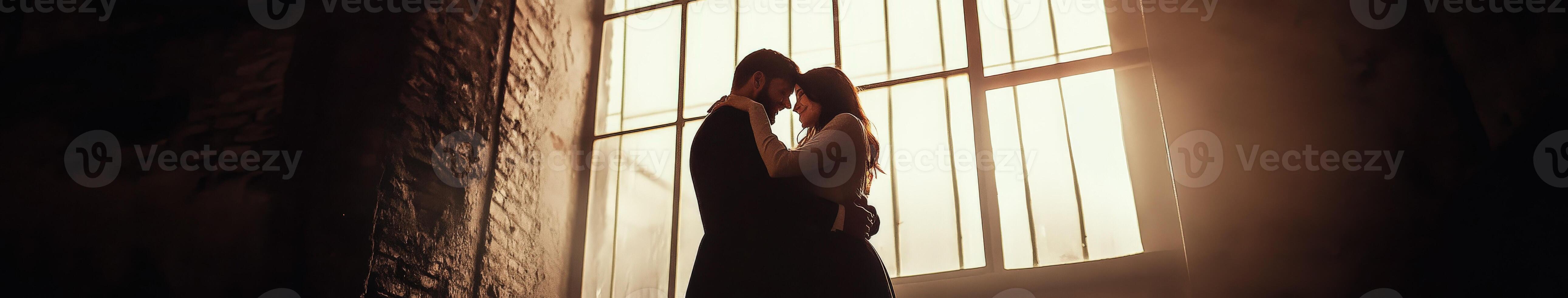 Couple embracing in a warm, sunlit room during a peaceful afternoon photo