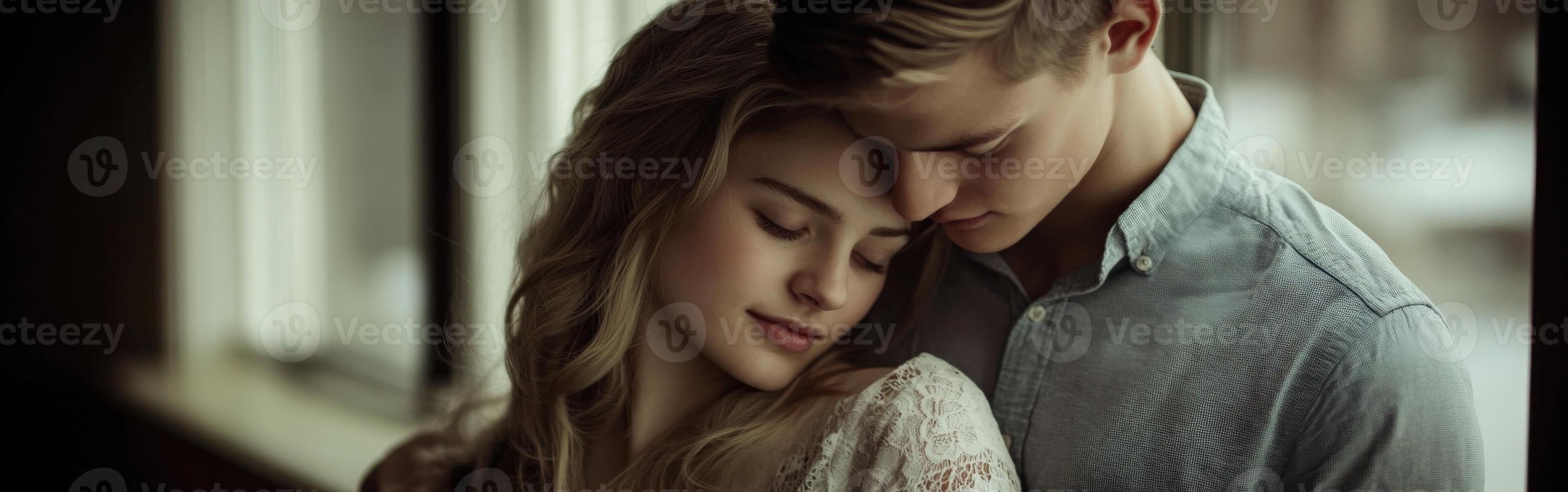 Young couple sharing a tender moment indoors during the afternoon photo