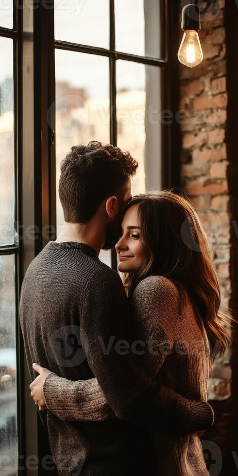 Cozy couple embraces by a window in a rustic cafe during sunset photo