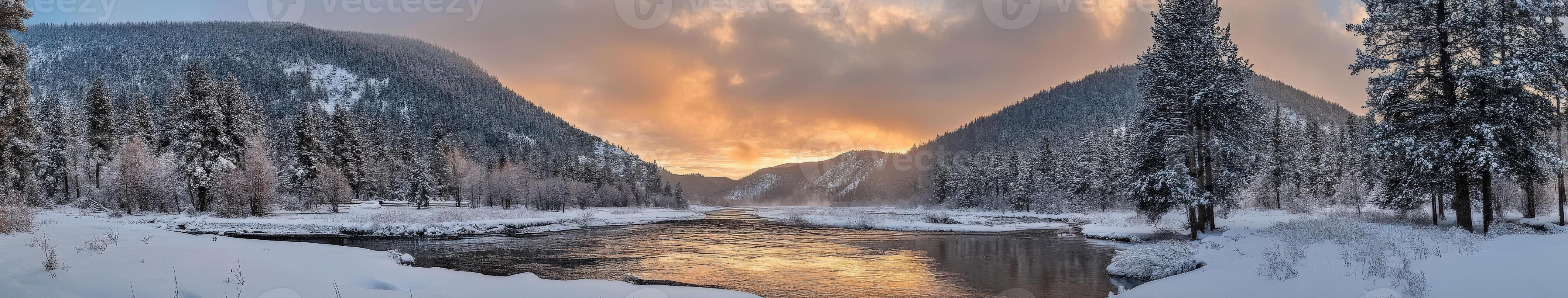 Snow-covered river valley at sunset with towering mountains in view photo
