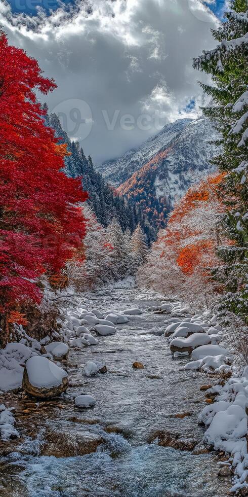 Majestic river valley with vibrant fall foliage and fresh snowfall photo