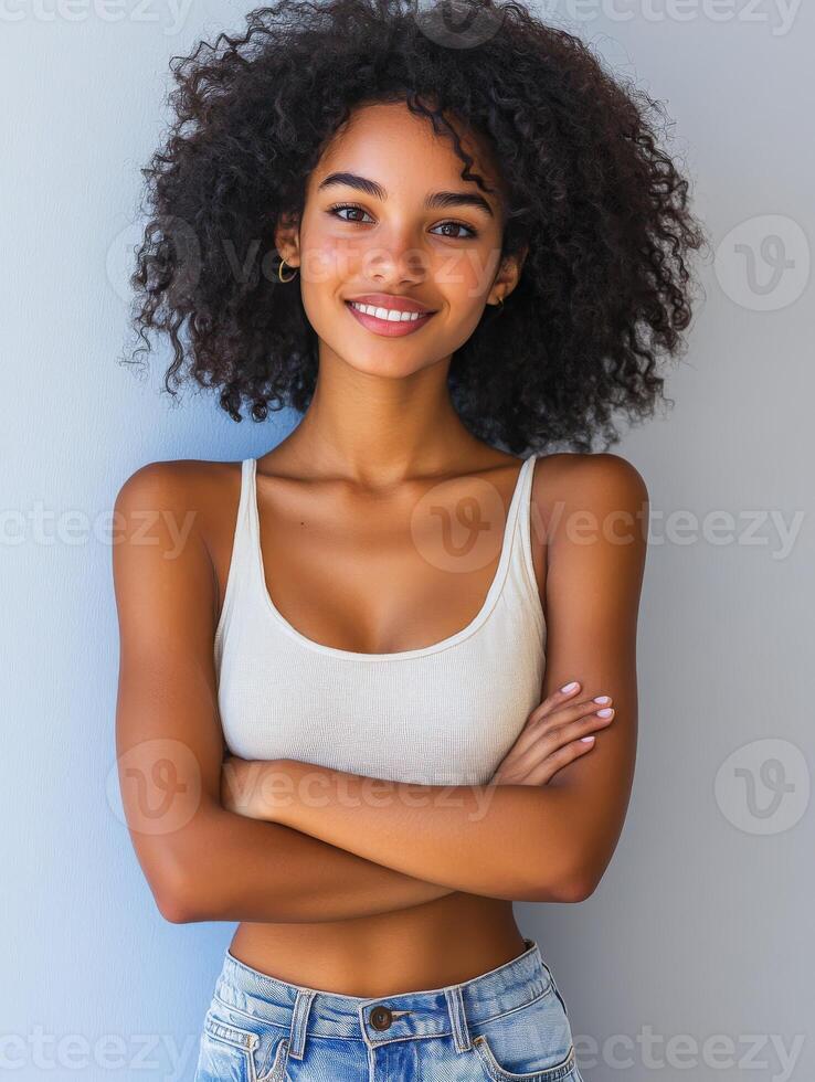 Woman with curly hair posing confidently against a light background photo