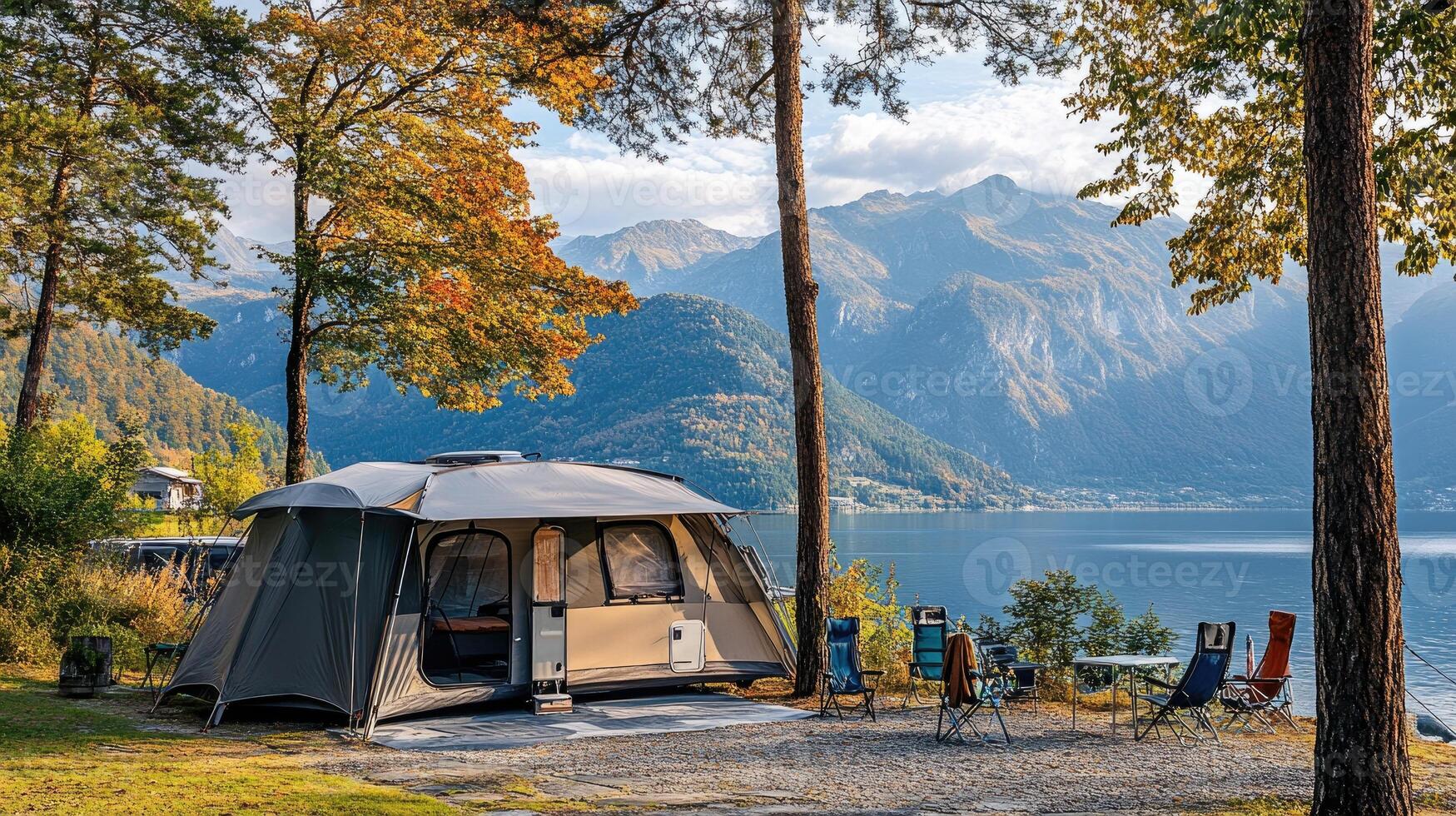 Large family camping tent with stunning lake and mountain view during autumn season photo