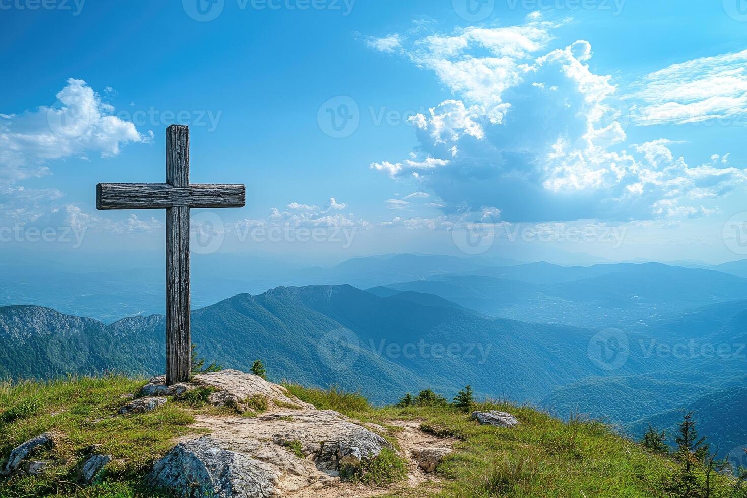Wooden cross standing on mountain top overlooking majestic vista photo