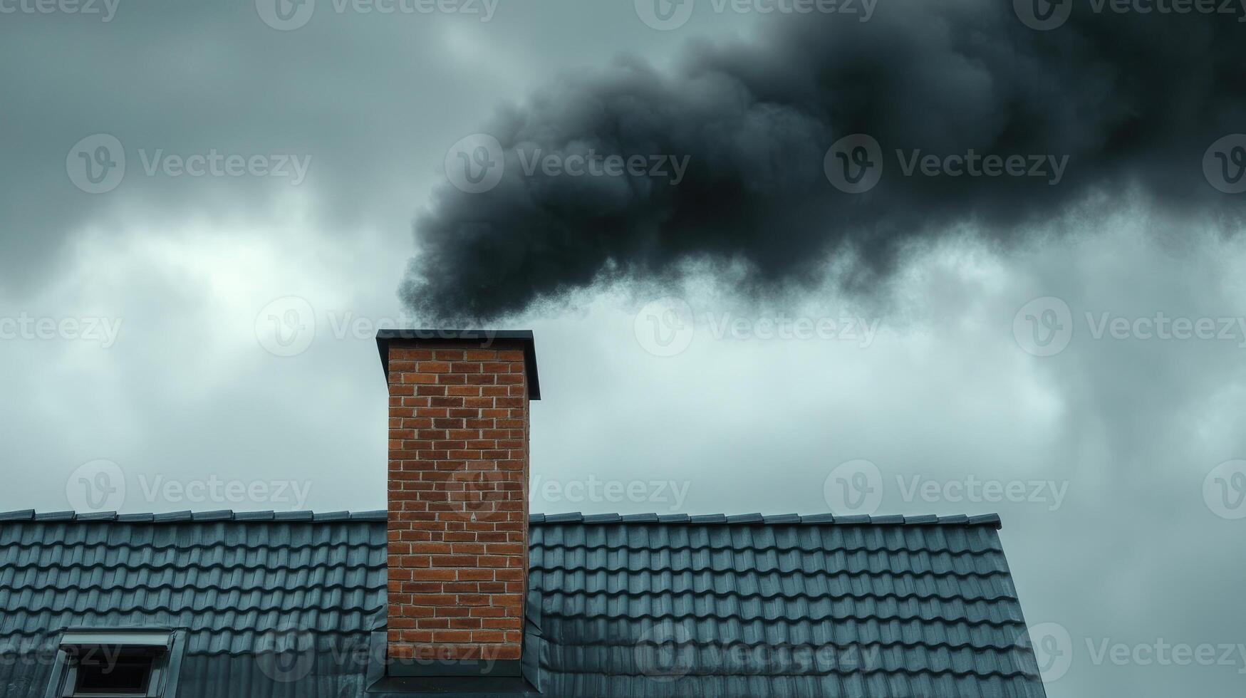 Brick chimney releasing black smoke into atmosphere on cloudy day photo
