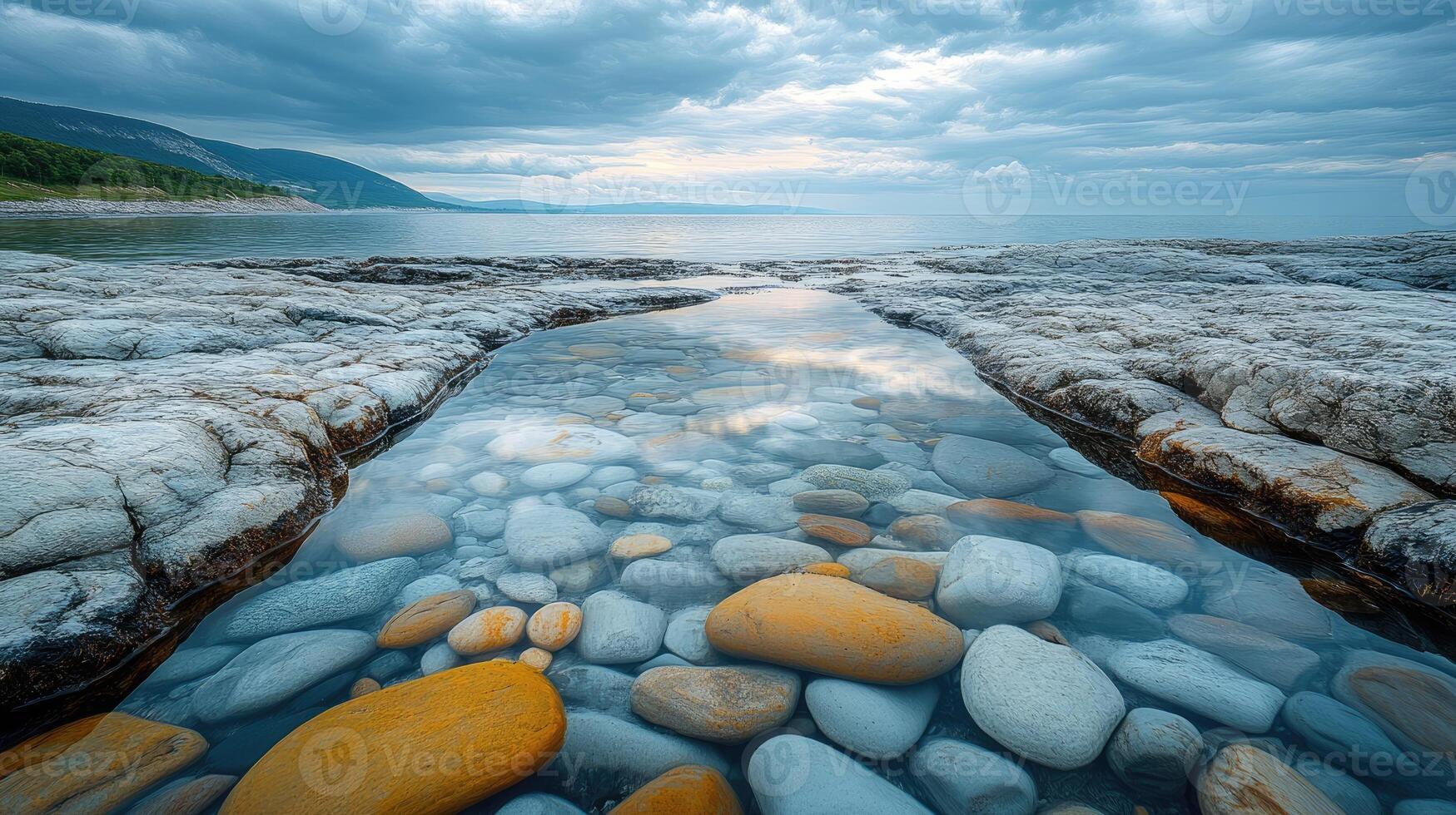 Crystal clear sea water flowing over rocks on the beach photo