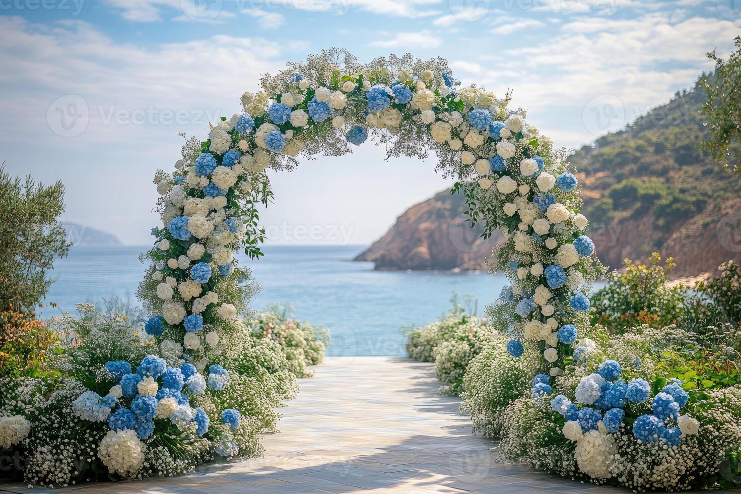 Beautiful wedding arch decorated with white and blue flowers stands overlooking a tropical ocean photo
