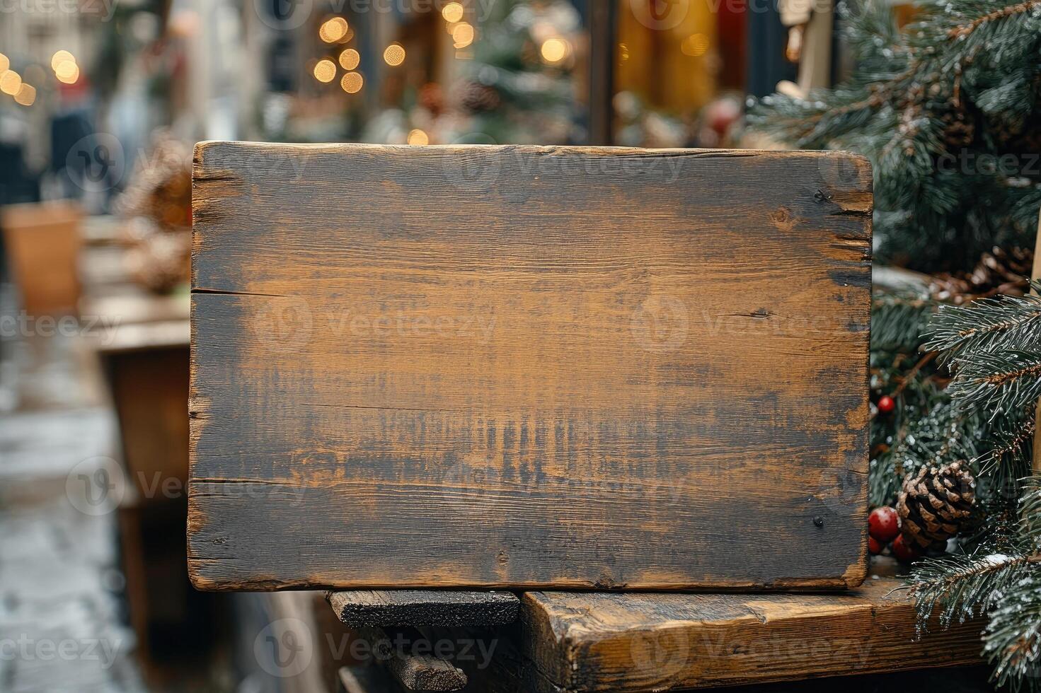 Empty wooden sign displaying at christmas market with people walking photo