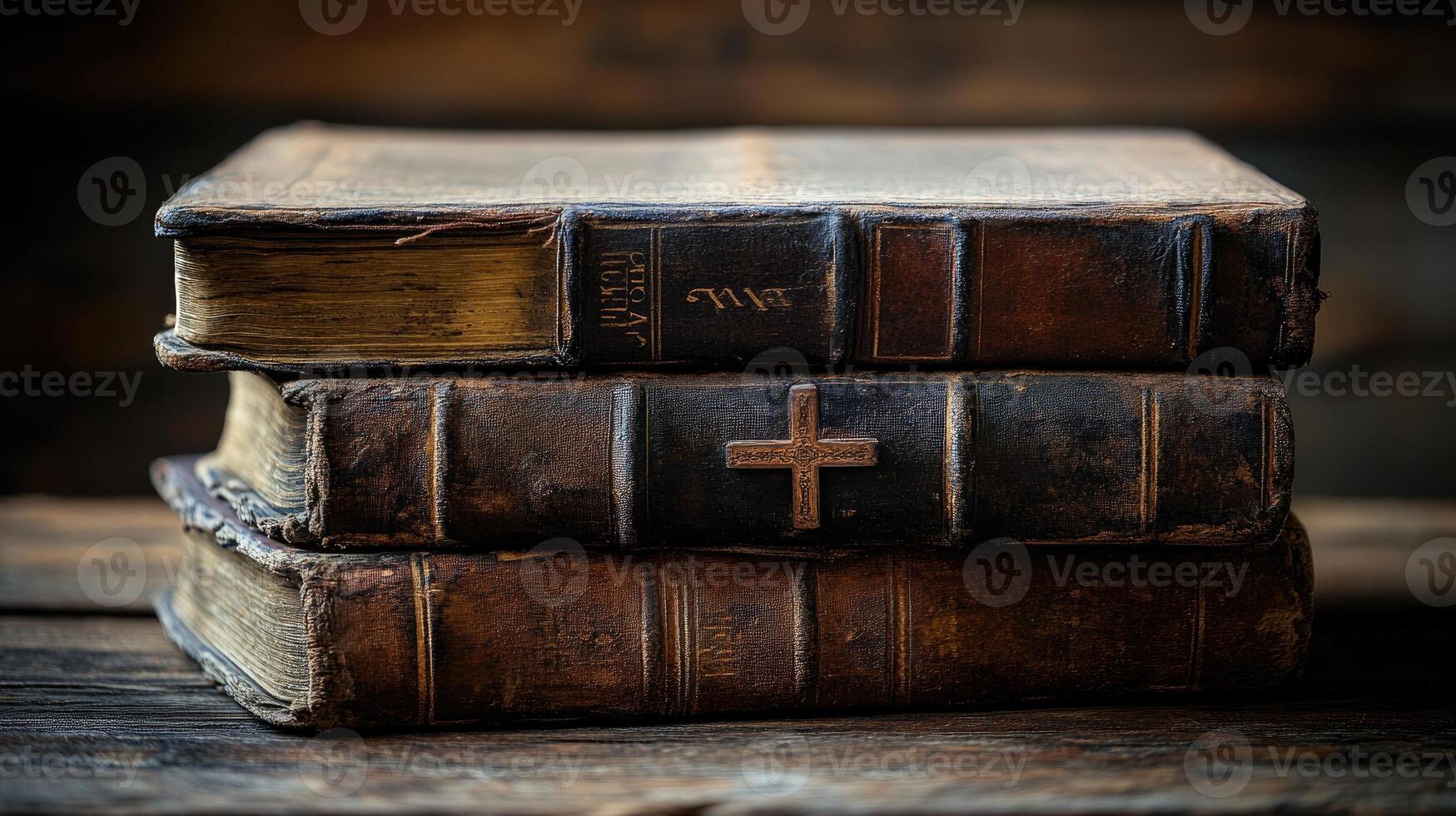 Stack of antique books with cross on wooden table conveying spirituality photo