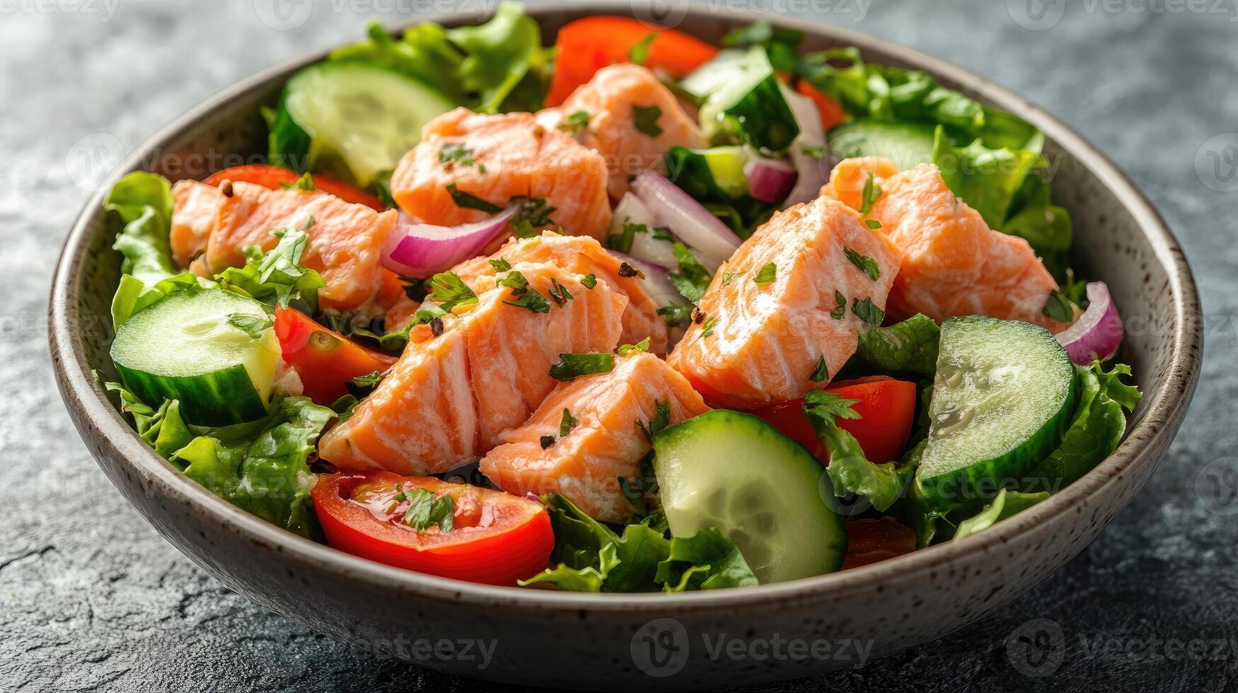 Delicious fresh salad with salmon and vegetables in a bowl photo