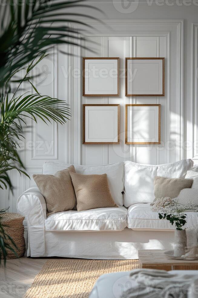Stylish living room interior with empty frames hanging on white wall above sofa photo