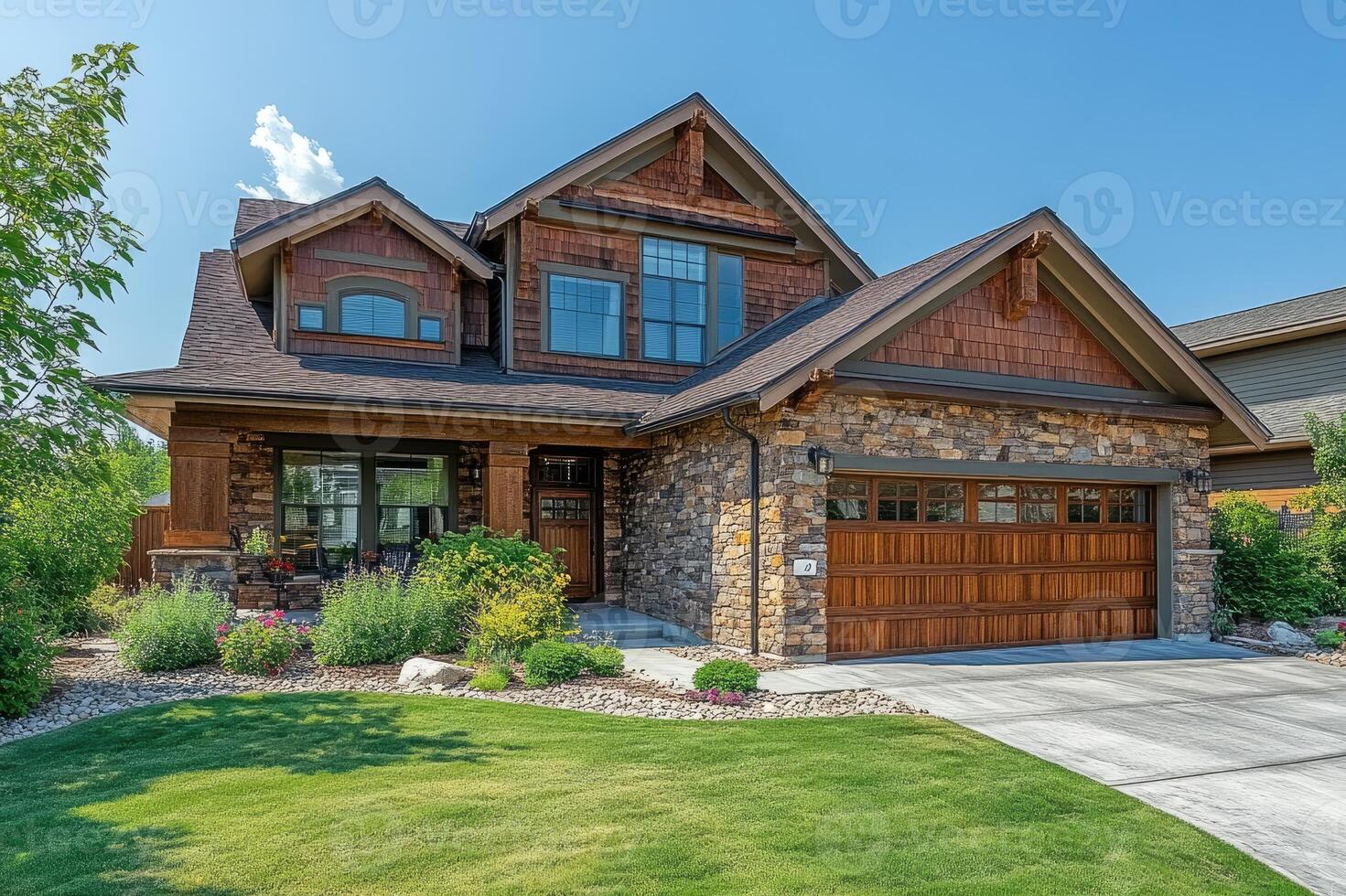 Beautiful craftsman style home with stone and wood siding on sunny day photo