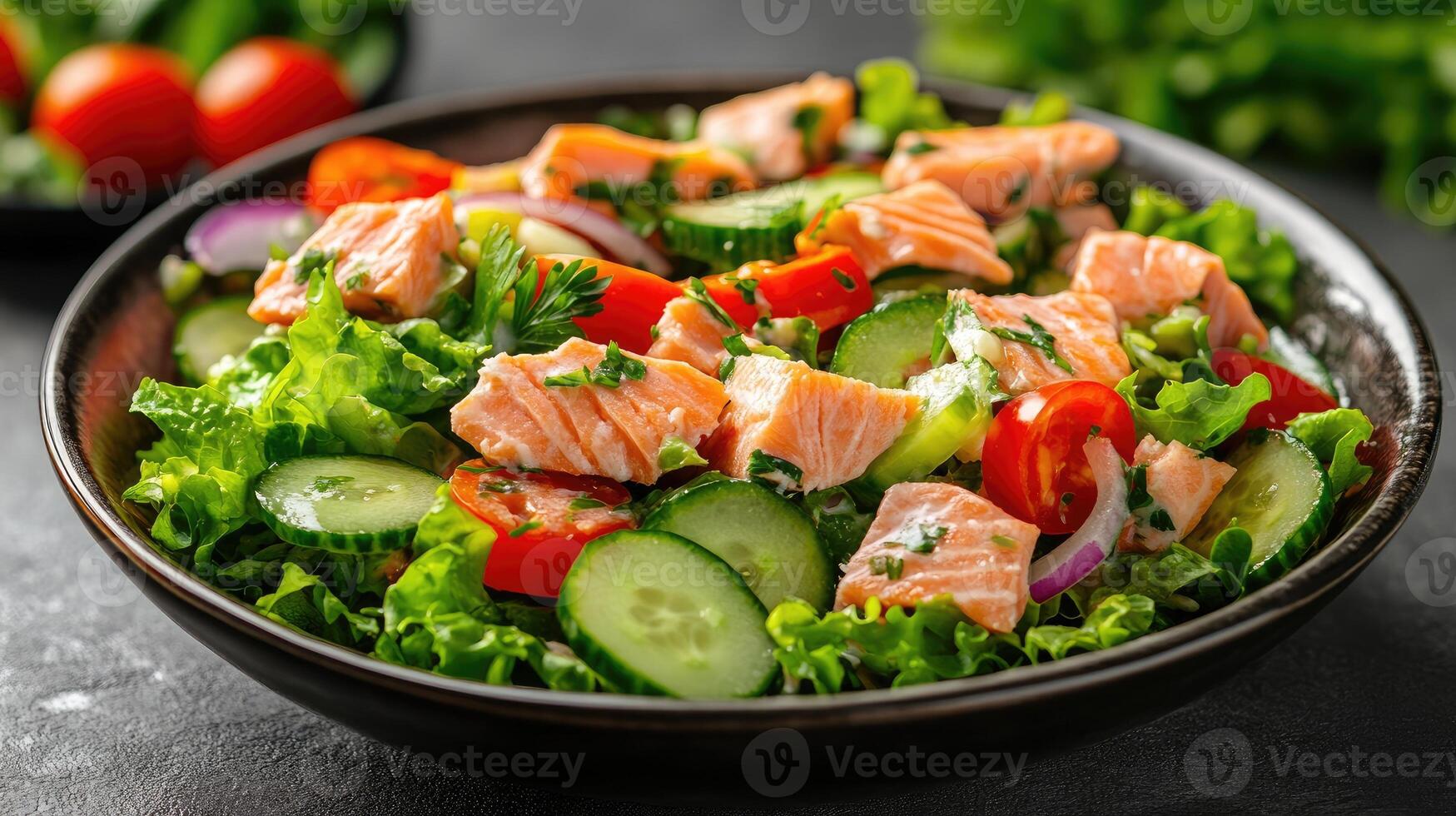 Delicious fresh salad with salmon and vegetables in a bowl photo
