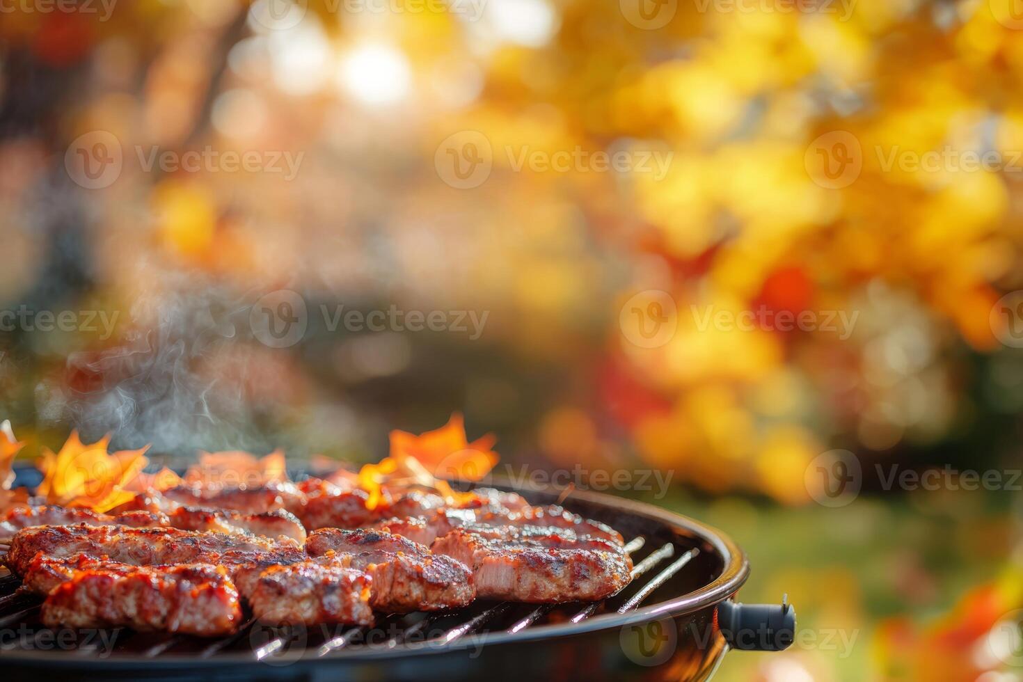 Delight in a warm and cozy autumn barbecue filled with expertly grilled meats, surrounded by the vibrant and rich colors of fall, all while enjoying a peaceful and inviting outdoor setting photo