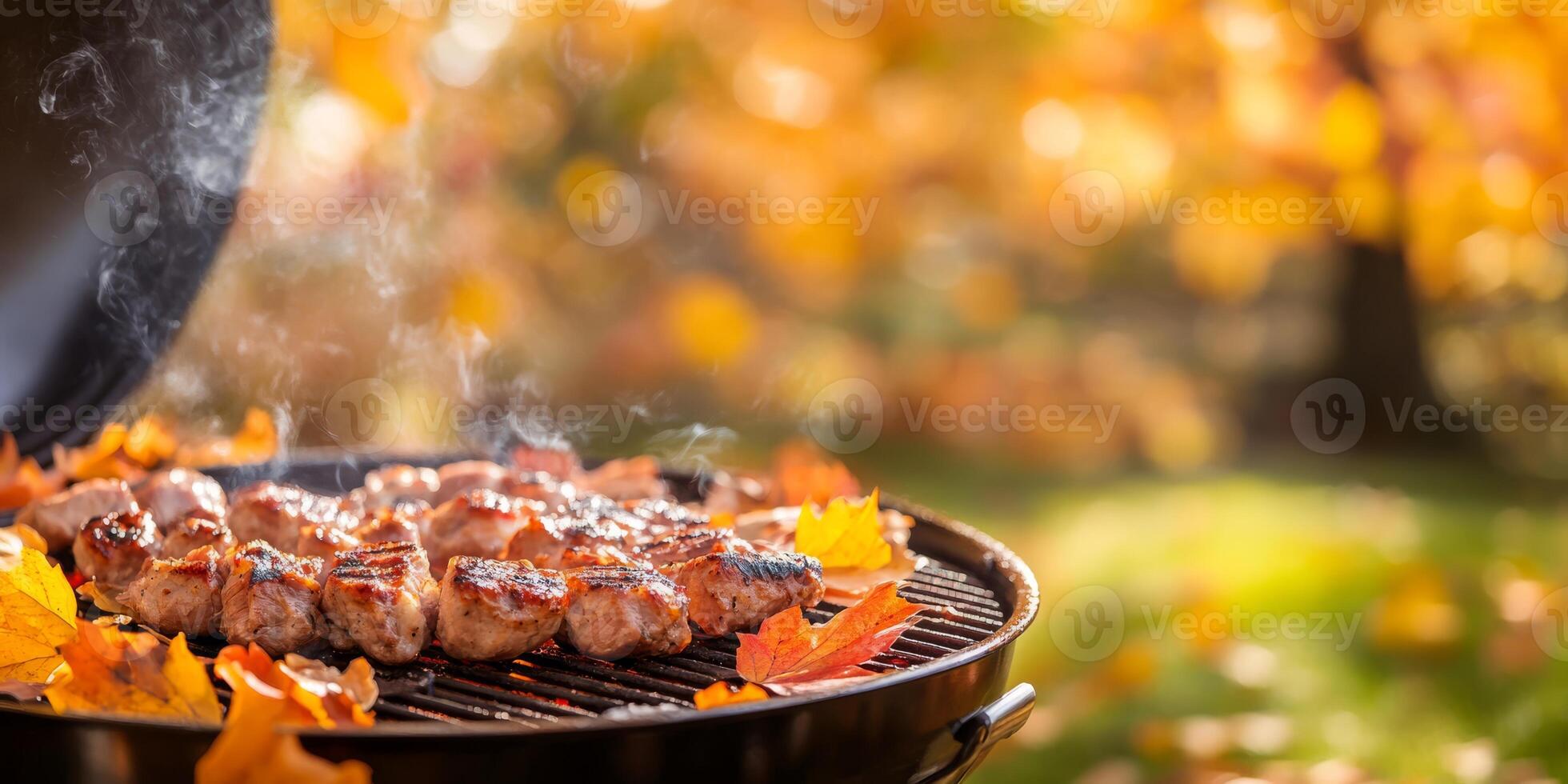 Enjoy a warm, cozy autumn barbecue featuring smoky grilled meats surrounded by the vibrant and colorful fall foliage in a beautiful rustic outdoor setting perfect for gathering family and friends photo