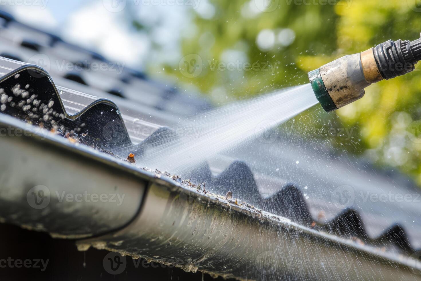 This image captures water powerfully spraying from a hose onto a roof gutter, framed by vibrant lush greenery, highlighting the importance of maintenance and cleanliness in an outdoor setting photo