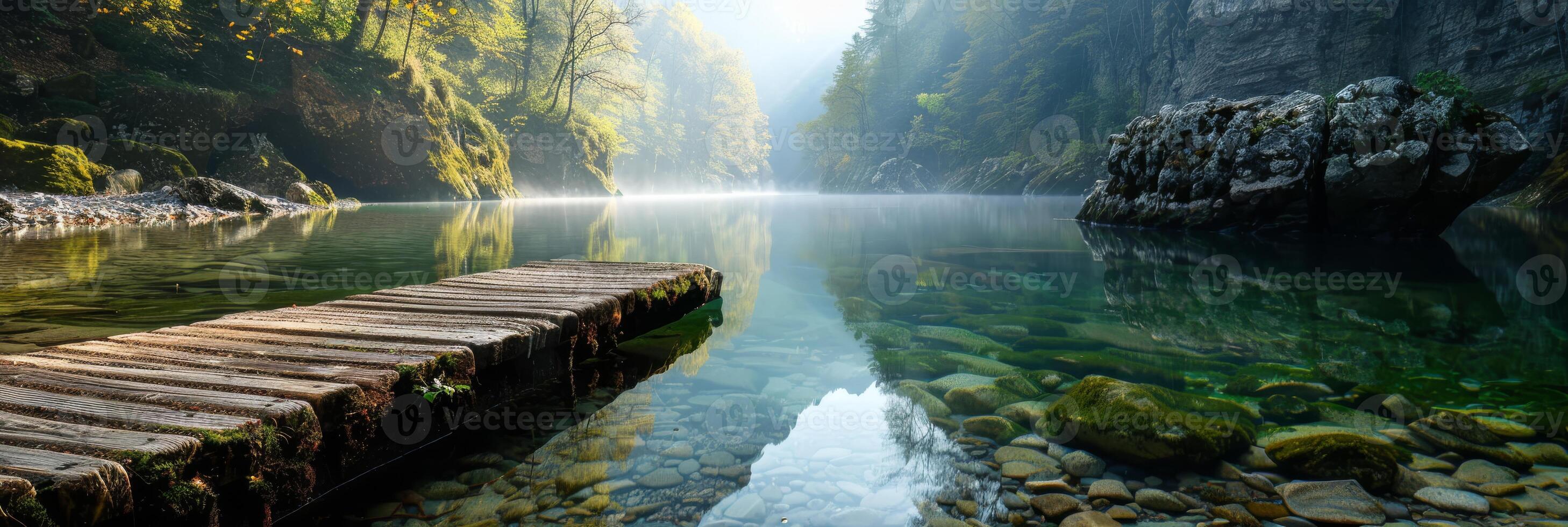 A breathtaking view showcases a tranquil mountain lake with a wooden dock, clear water, and dense forest around photo