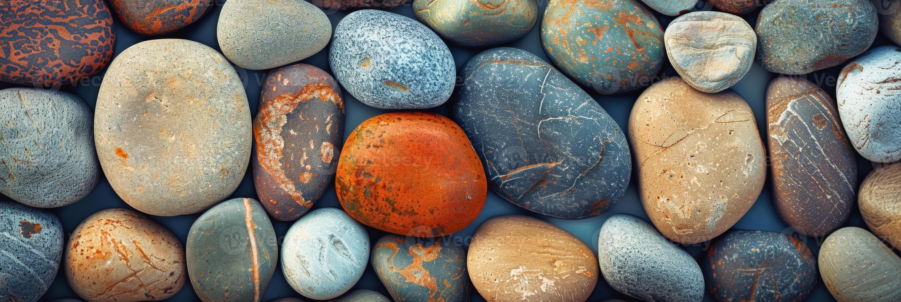 In a closeup view, colorful river stones form a pebble texture, creating a harmonious and balanced composition photo