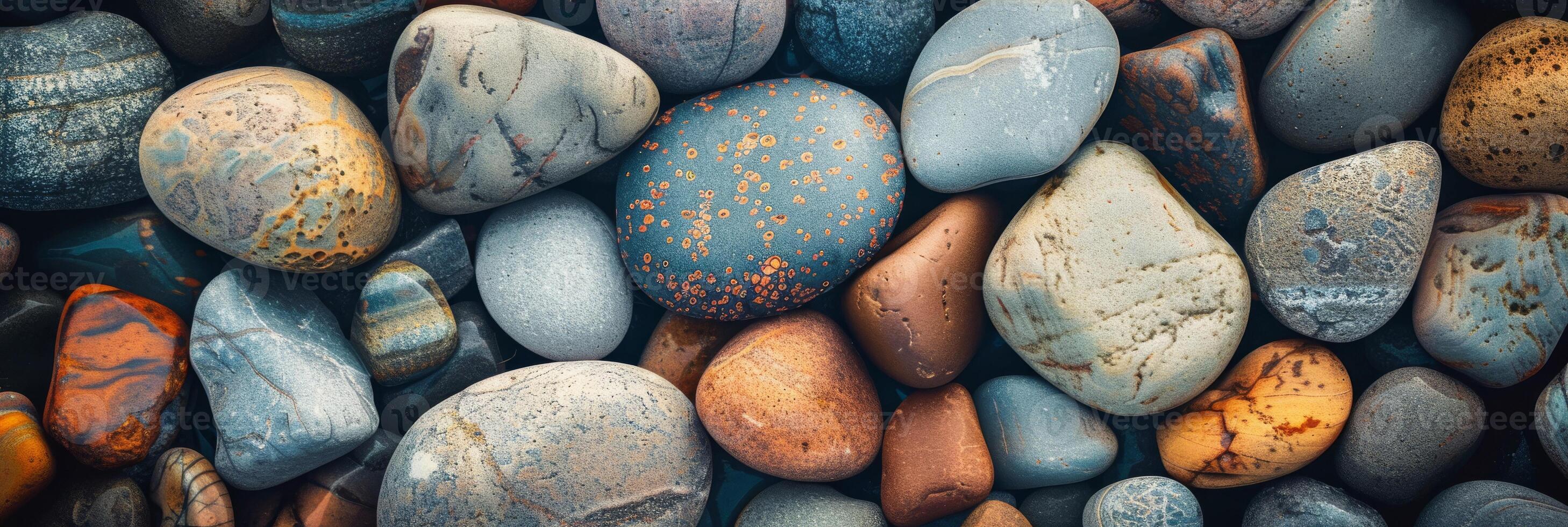 High-resolution image of various smooth, colorful pebbles and stones, perfect for backgrounds and textures. photo