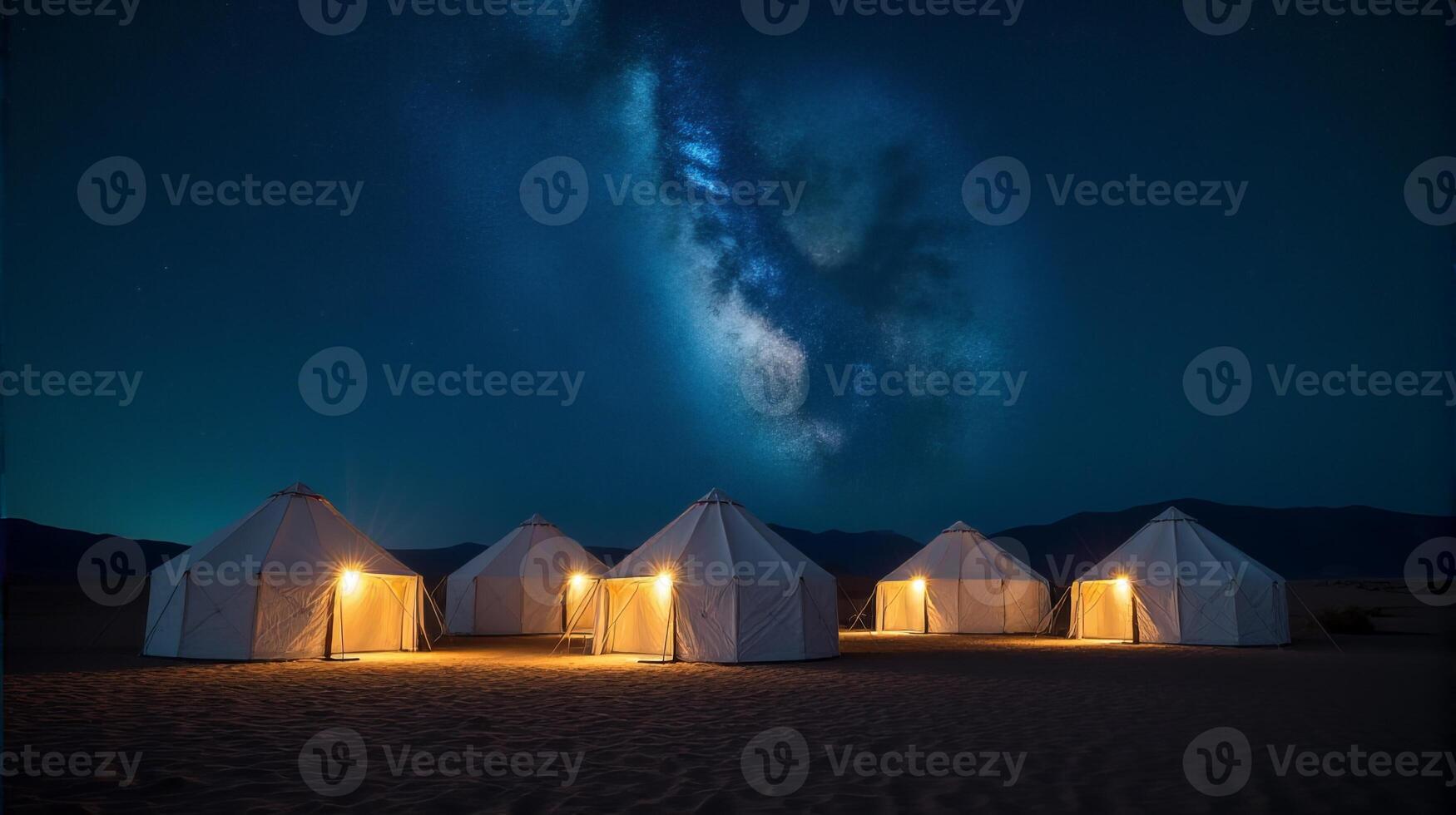 Serene Desert Night Scene Featuring a Cluster of Traditional White Tents Under a Breathtaking Milky Way Galaxy photo