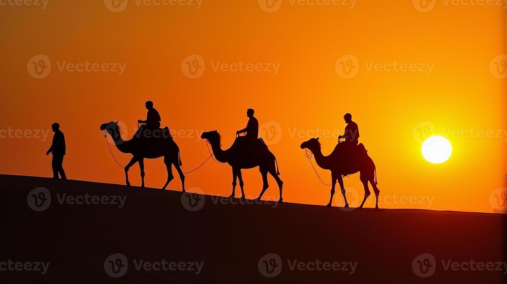 Silhouette of Camel Riders Against an Orange Hued Sky on a Desert Dunes Under Dramatic Sunset photo