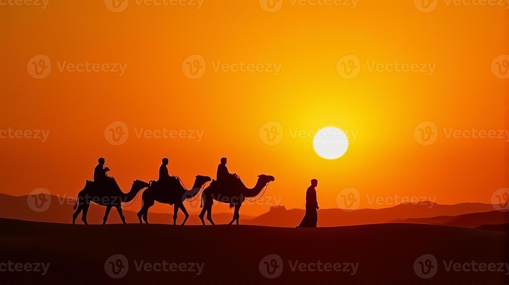 Silhouette of Camel Riders Against an Orange Hued Sky on a Desert Dunes Under Dramatic Sunset photo
