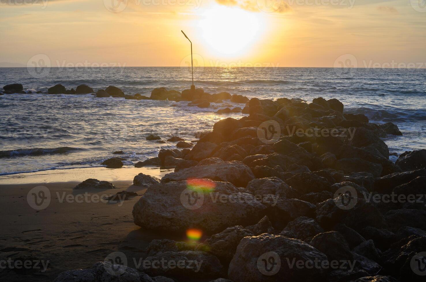 Sea landscape, sand beach and rocks on foreground. photo