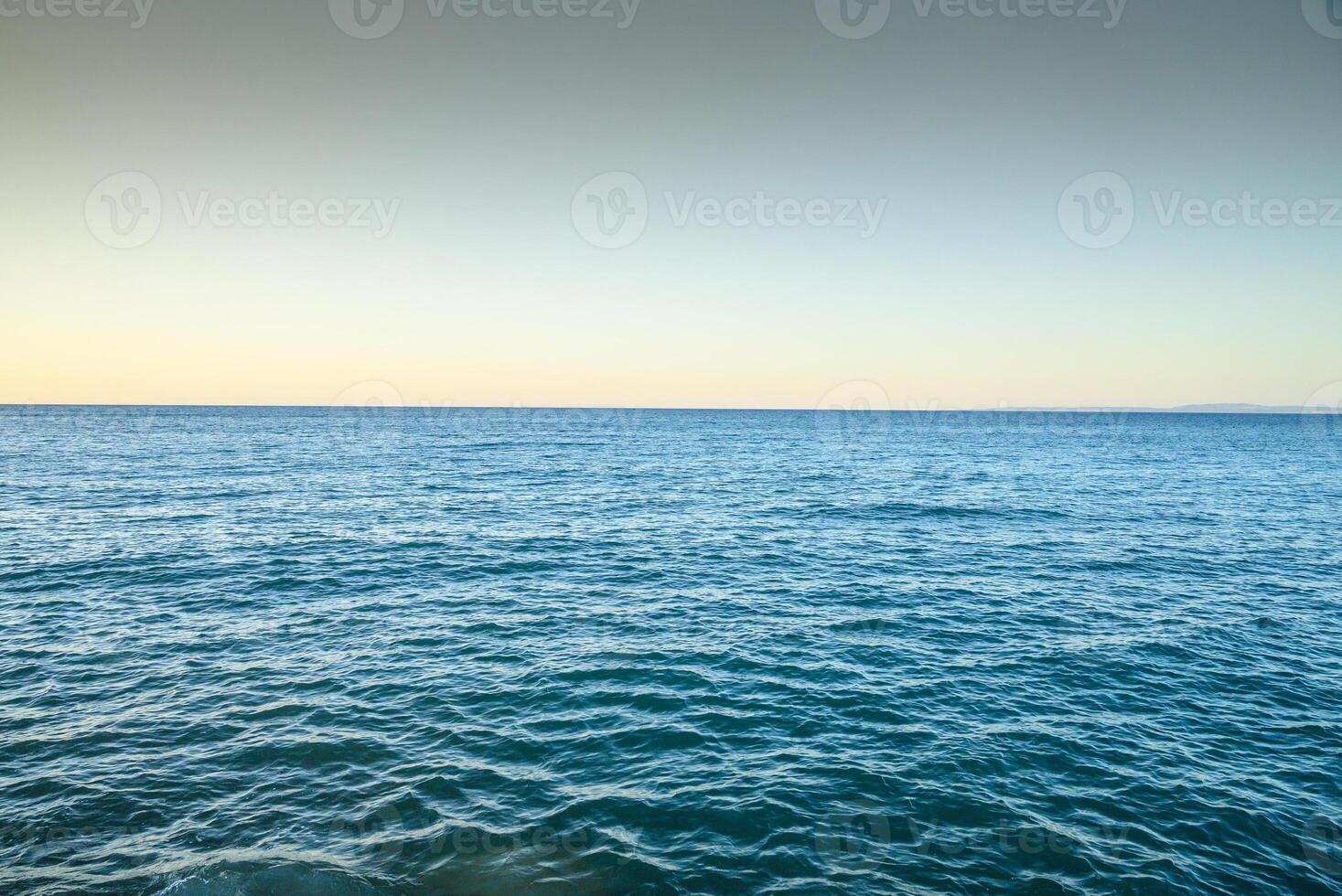 Blue sea water surface on sky photo