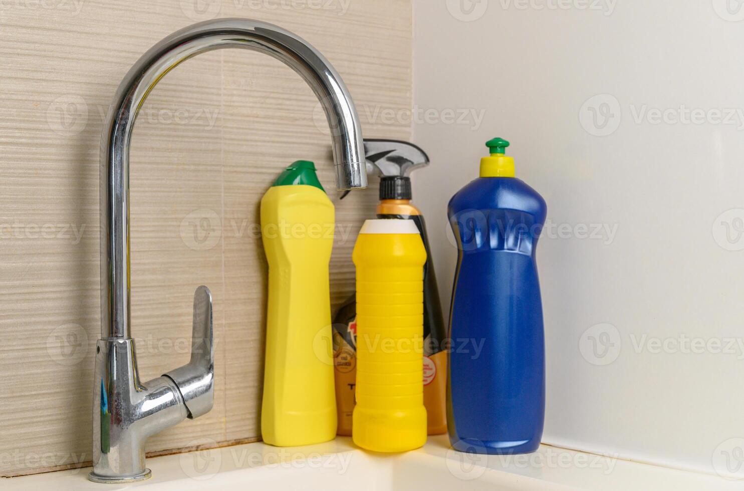Cleaning product plastic container for house clean on wooden table and blue background . household chemicals photo