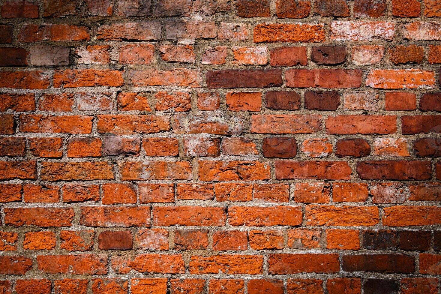 Red brick wall. Texture of old dark brown and red brick wall panoramic backgorund. photo