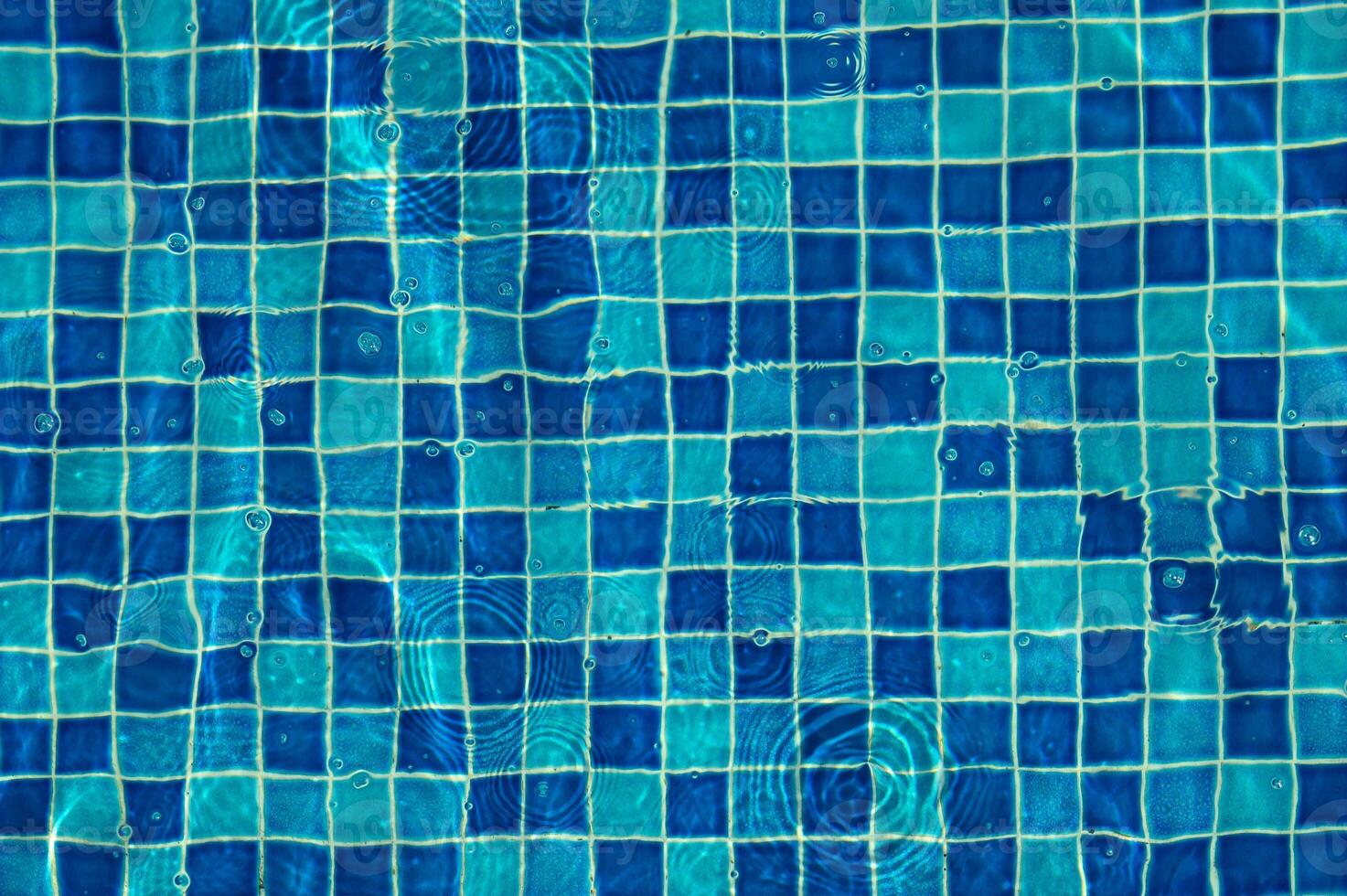 Underwater view of sunlight reflecting on the swimming pool floor background photo
