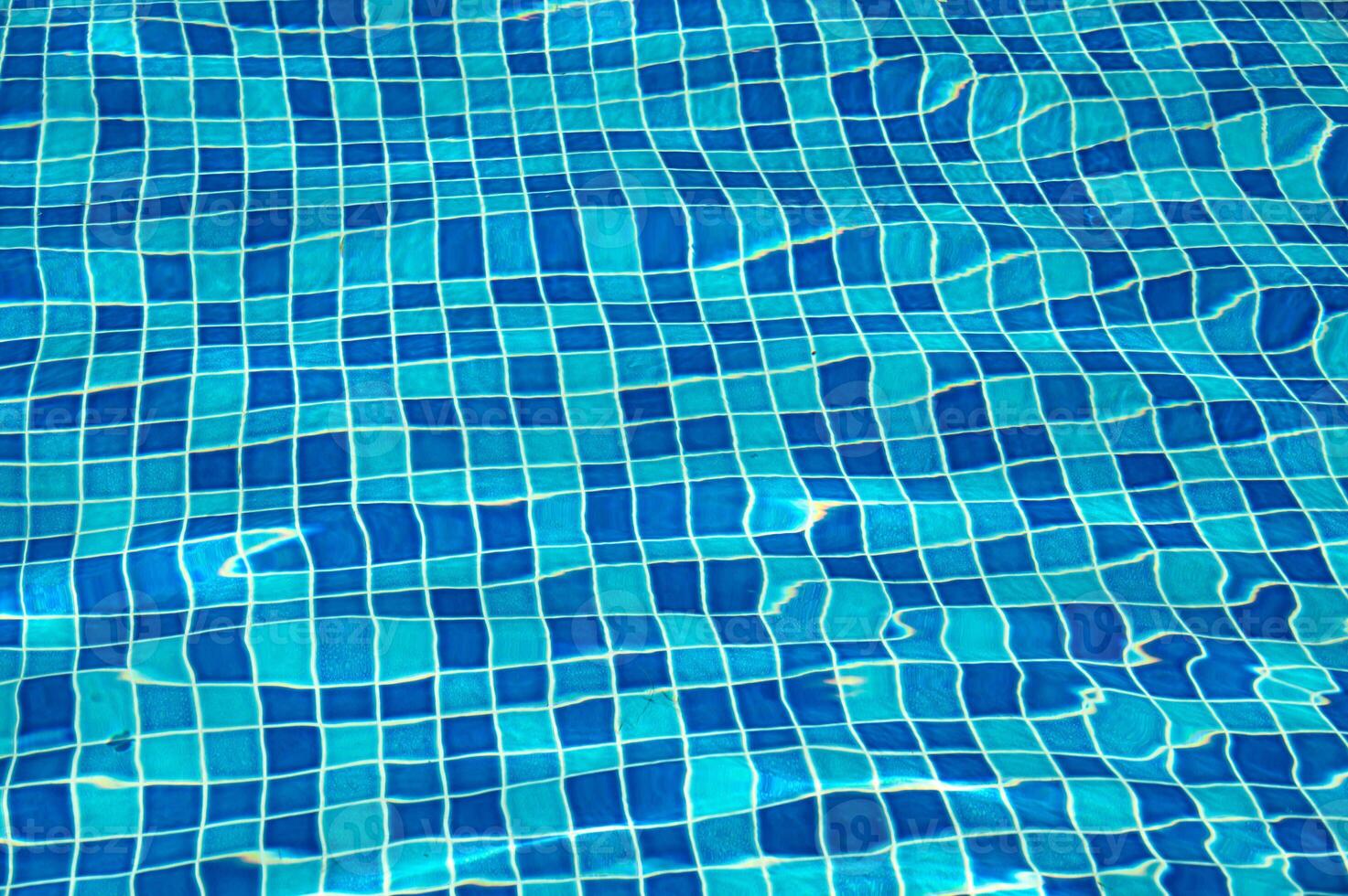 A blue pool shines on a summer day photo