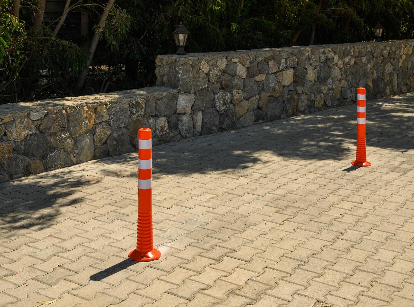 Sidewalk anti-parking bollards with reflective tape in the parking lot 13 photo