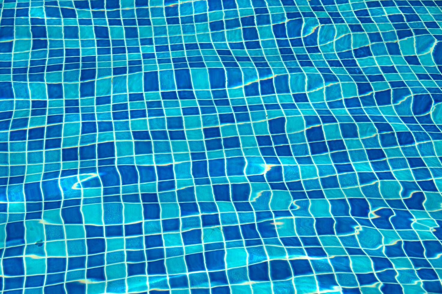 A blue pool shines on a summer day photo