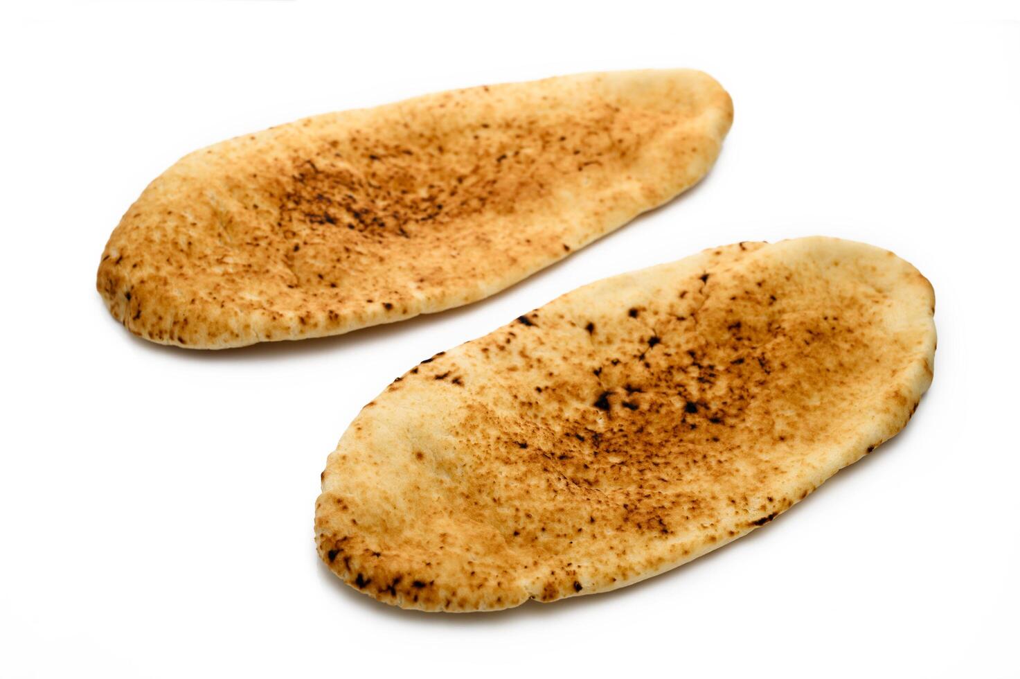 whole greek pita bread isolated on white background photo