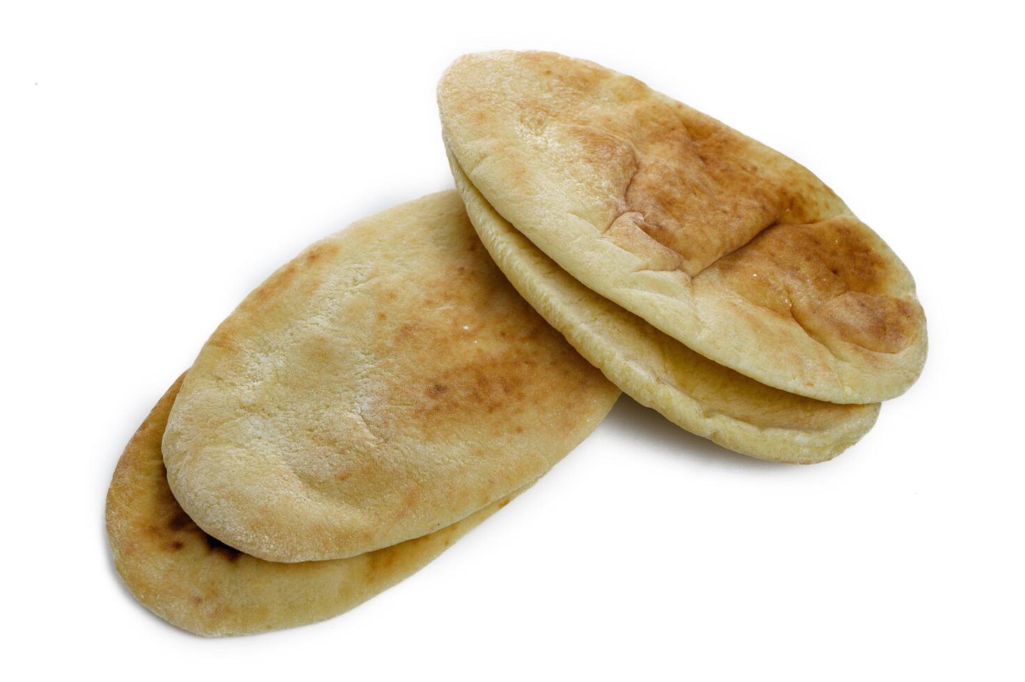 Cut fresh pita bread on white background, top view photo