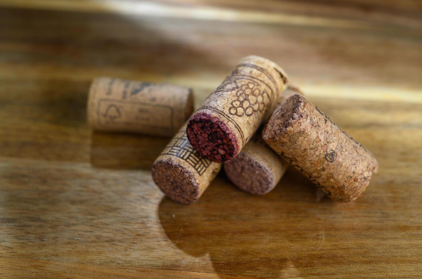 a pile of wine corks on a wooden table photo