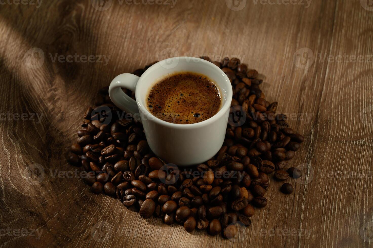 Cup of coffee and beans on a table. photo