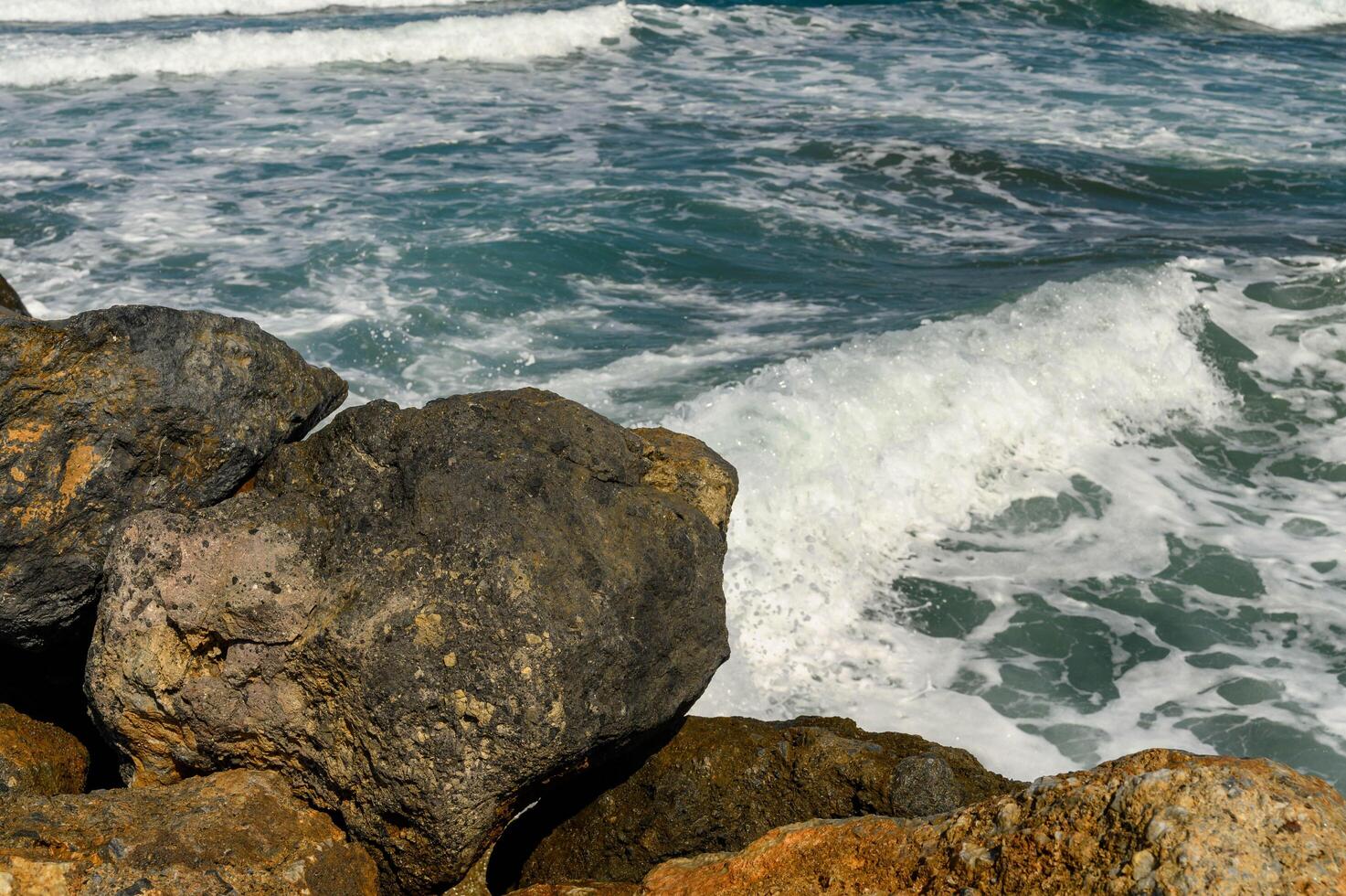 autumn waves of the mediterranean sea crash on the rocks near the coast of cyprus photo