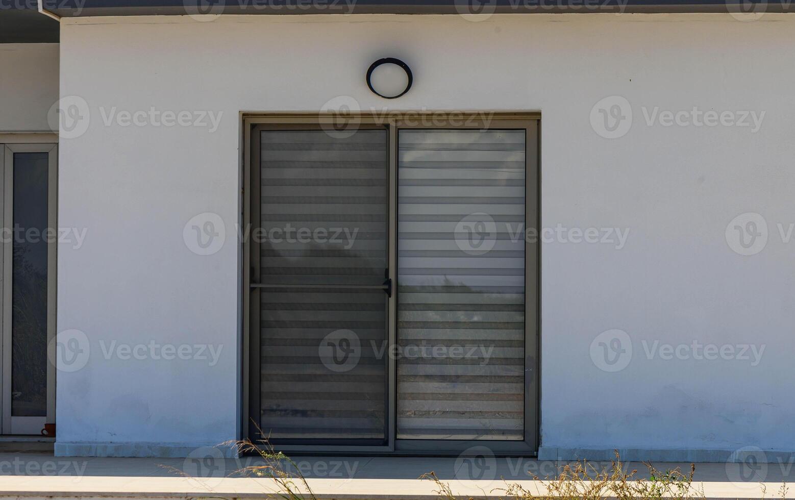 windows with blinds in a house in the village photo