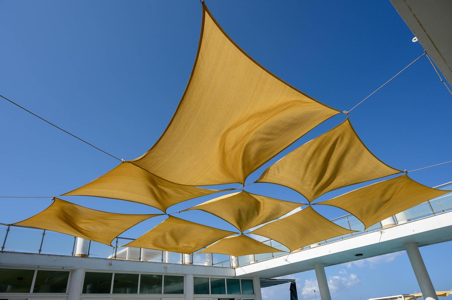 beach umbrellas against the blue sky Multiple large summer nylon patio sun shade umbrellas photo