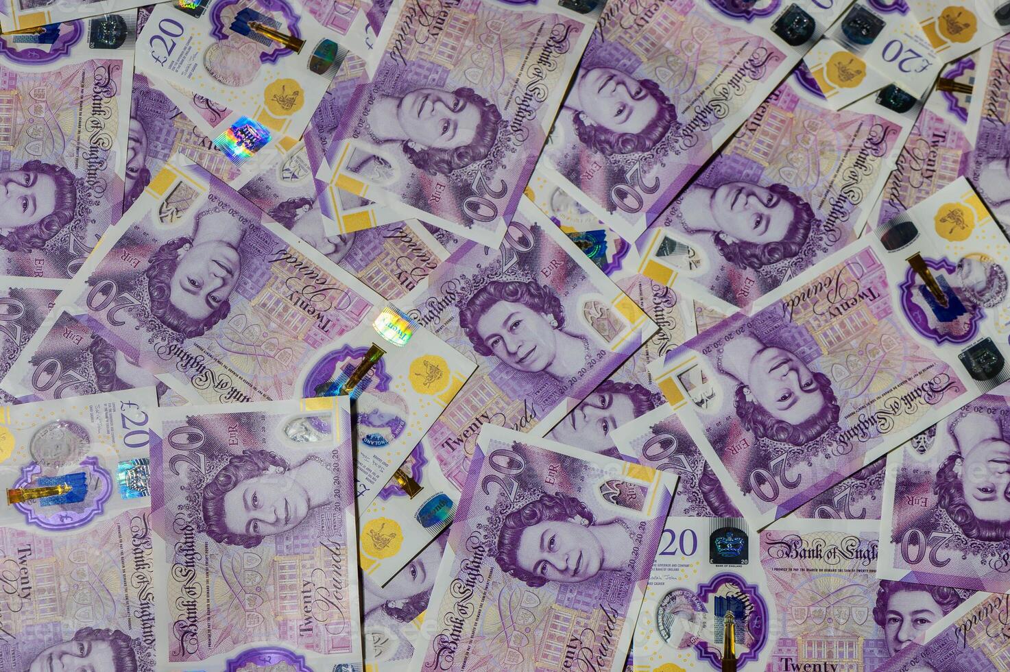 20 pound sterling bank notes closeup view business background 2 photo